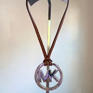 Michael Kors L2" Round Embossed Silver MK Bag Charm w Brn Leather Strap Like New